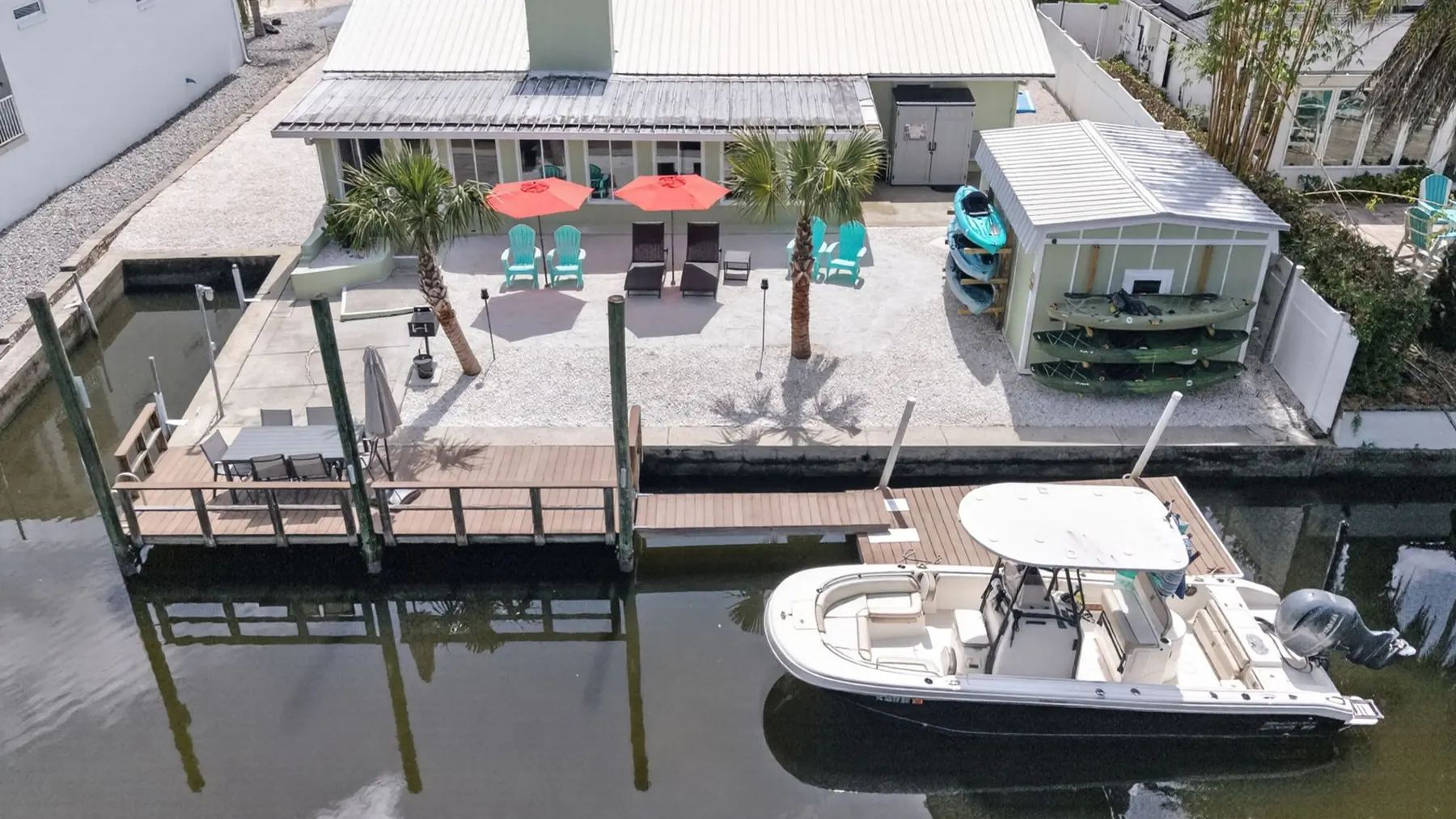 Aerial view of the private dock, patio and kayaks at My Scallop Inn on Kings Bay, Crystal River