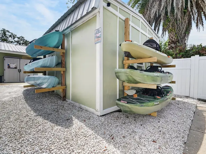 Rack of complimentary kayaks beside the house