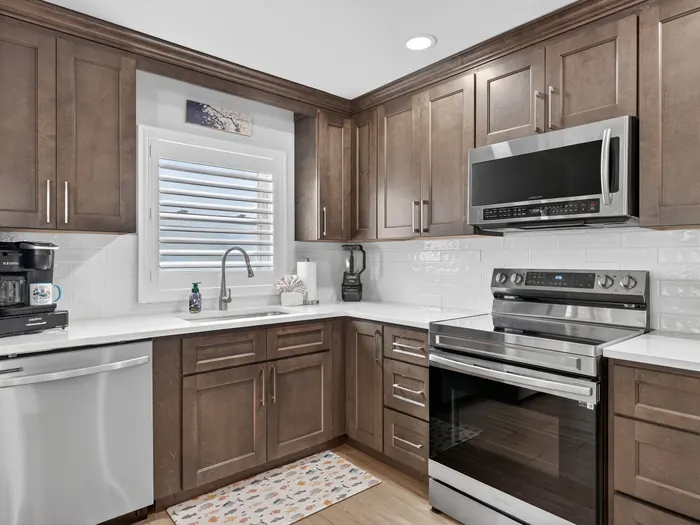 Fully equipped kitchen with quartz counters and stainless appliances