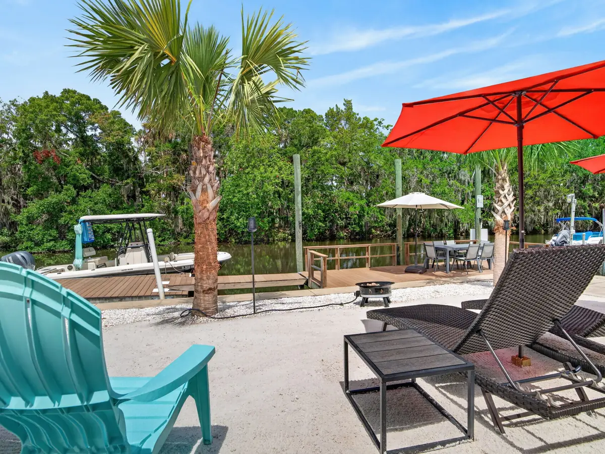 Waterfront patio with fire pit, loungers and dock at My Scallop Inn